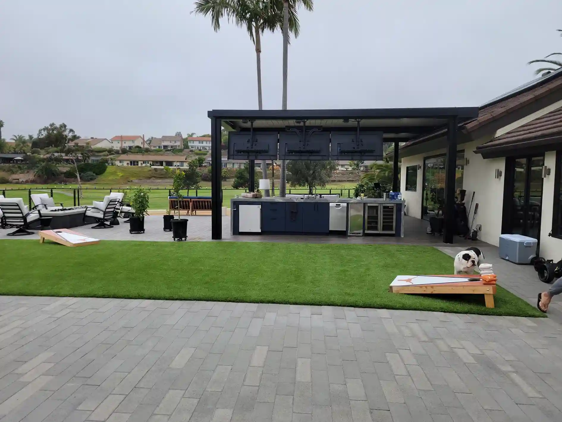 Photo of a paver patio with pergola and synthetic turf 